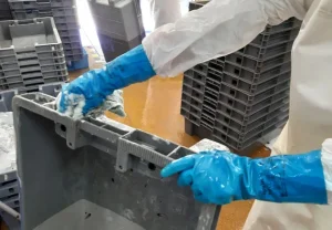 A plastic box for fish transportation, being cleaned.